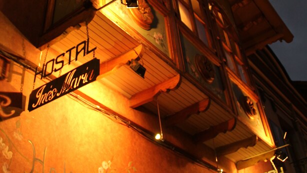 A building with a sign reading "HOSTAL" and "Hotel Maria."