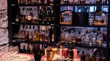 A bar area with shelves of liquor bottles and glasses.