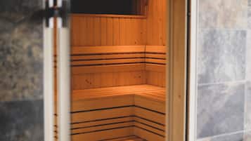 A sauna with wooden benches and a tiled floor.