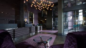 Welcome to our lobby, featuring a reception desk and comfortable seating area with a coffee table.