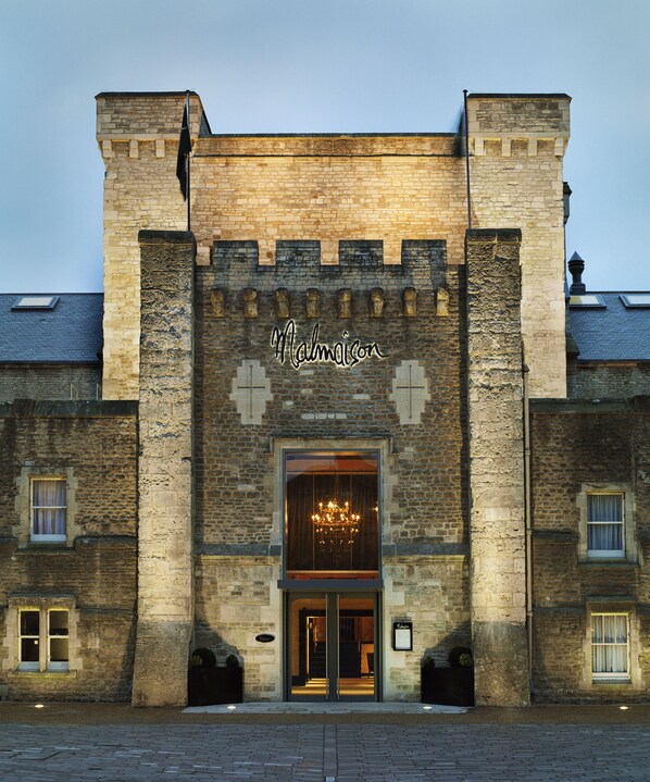 A historic building with a prominent entrance, a chandelier, and the name "Malmaison" displayed above the doorway. - Malmaison Oxford (Oxford)