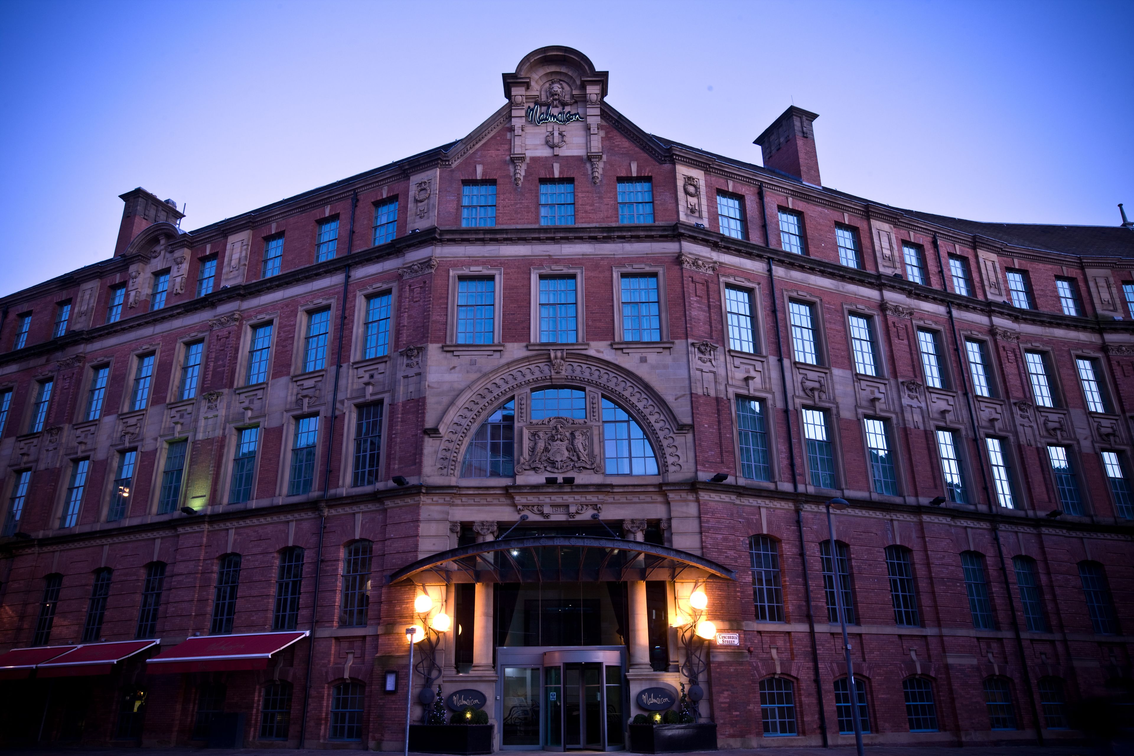 A large, historic building with a prominent entrance and arched windows.