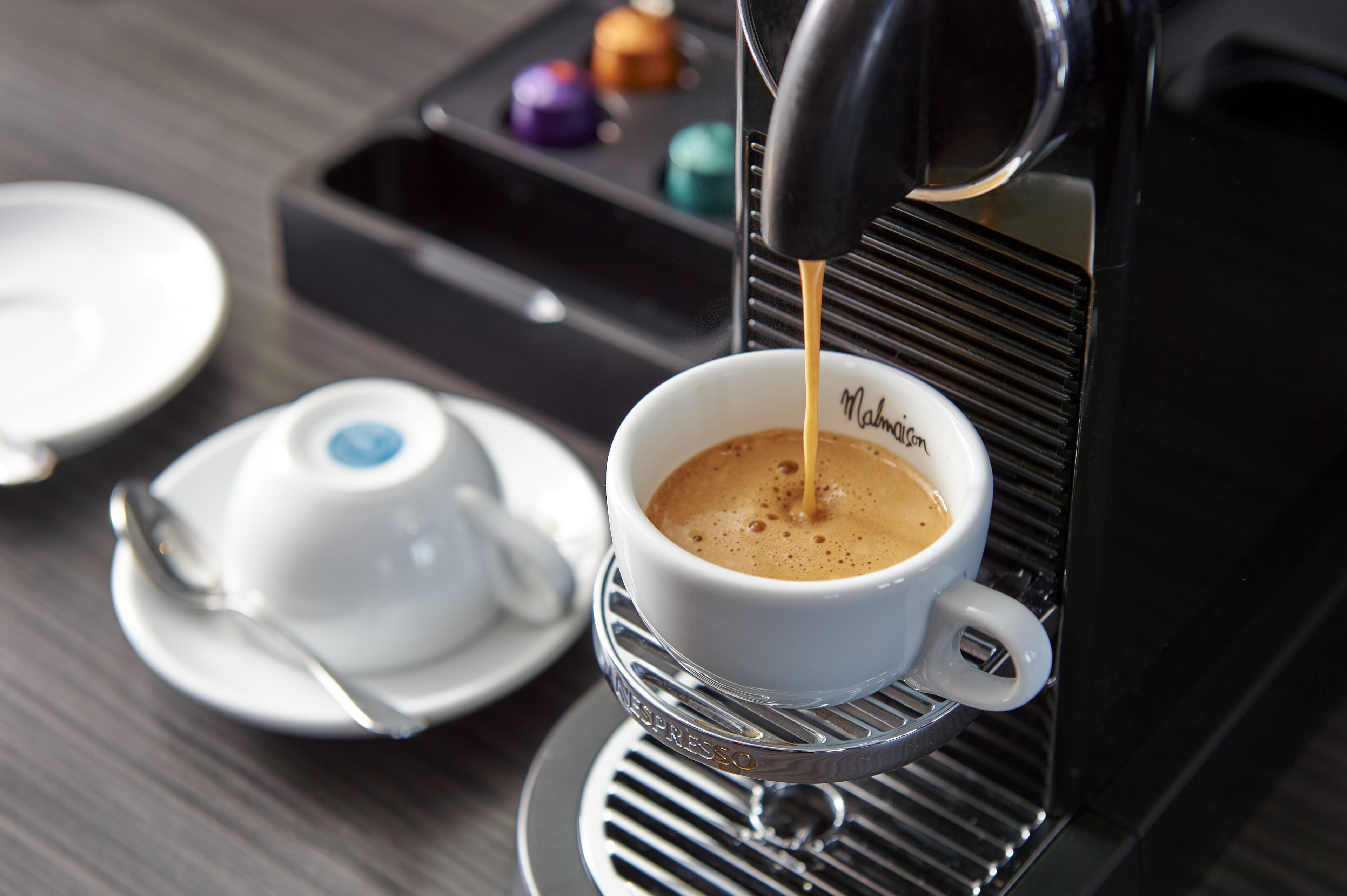 A cup of coffee being made with an espresso machine.