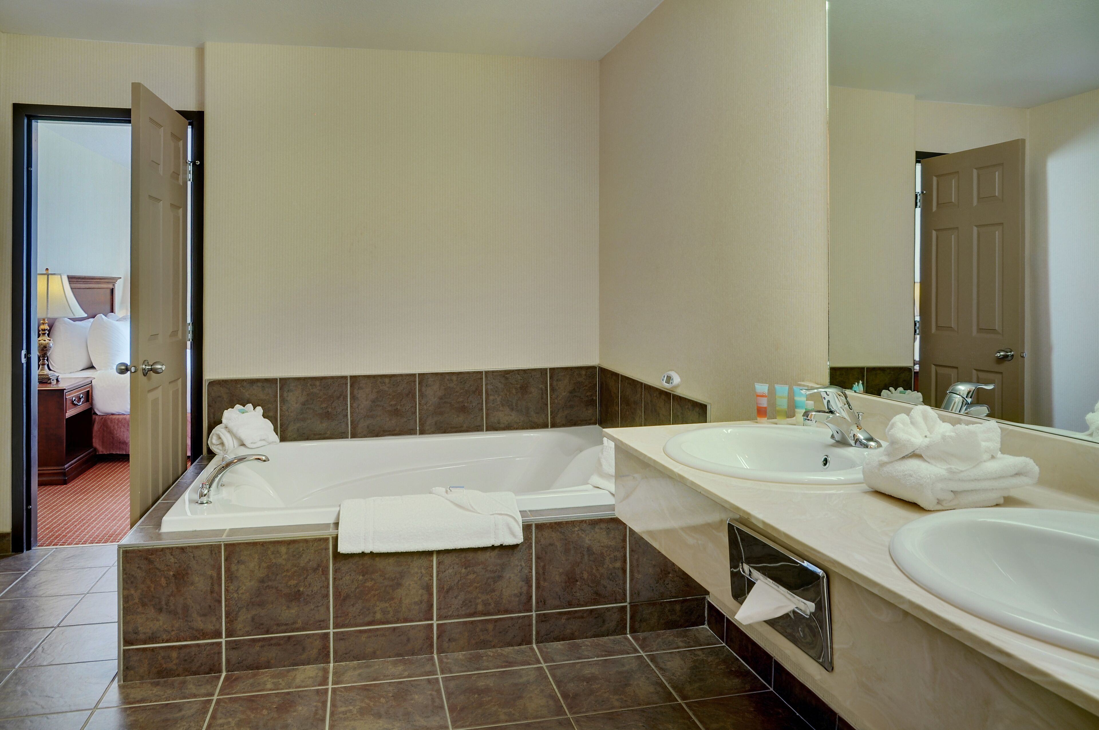 signature suite, 1 bedroom, jetted tub | bathroom | designer toiletries, hair dryer, towels, soap
