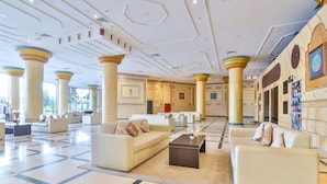 A spacious lobby with a checkered floor, multiple seating areas, and large columns. - Crown Palace Hotel Ajman (Ajman)