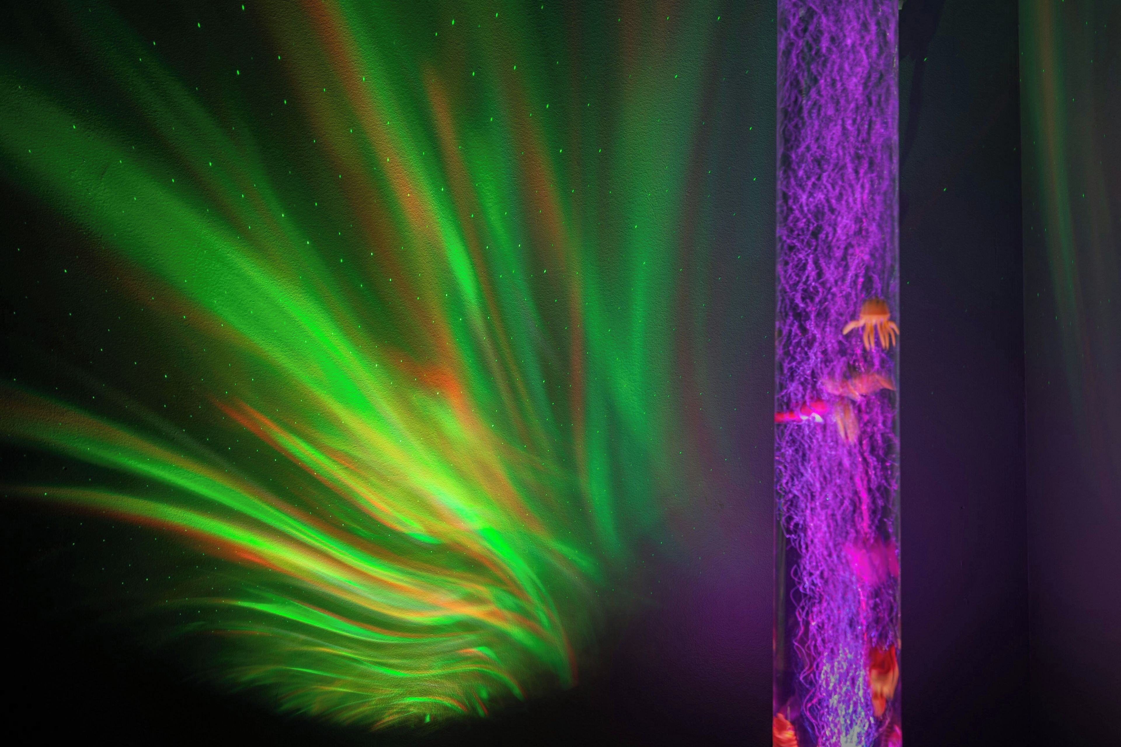 A view of the Northern Lights with a vertical element on the right.
