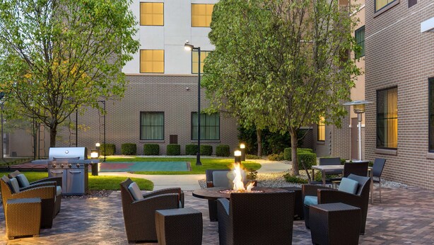 An outdoor patio with wicker furniture, a fire pit, and a barbecue grill. - Residence Inn Youngstown Warren/Niles (Niles)