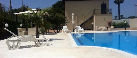 Seasonal outdoor pool, pool loungers