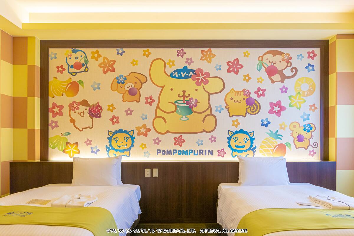 A hotel room with two beds, a colorful wall mural, and a checkered wall design.
