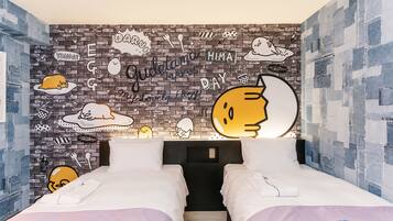 A room with two beds, a brick-patterned wall, and various doodles and text.
