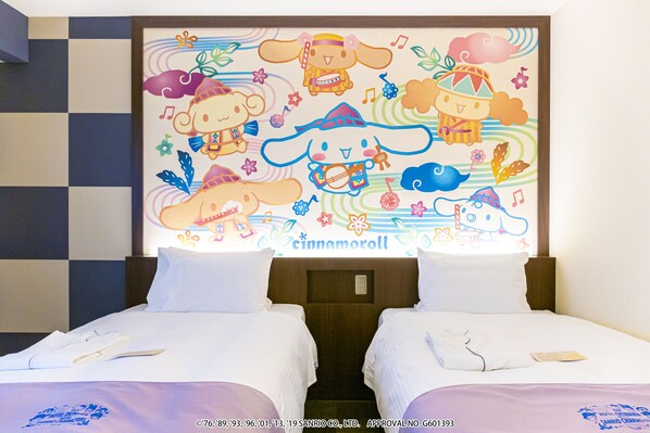 A hotel room with two beds, a checkered wall, and a colorful mural on the headboard.