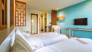A hotel room with two beds, a TV, a desk, and a bathroom visible through an open door. - Siamaze Hostel (Bangkok)
