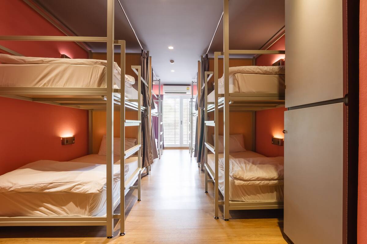 A corridor with bunk beds in a hotel room.