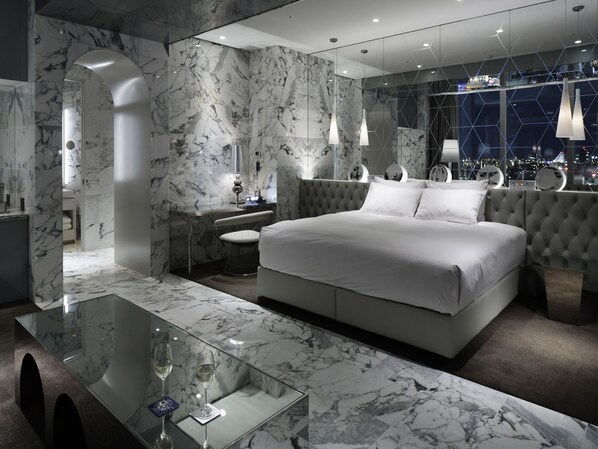 A modern hotel room with a marble bathroom, a glass coffee table, and a city view. - Shinjuku Granbell Hotel (Tokyo)
