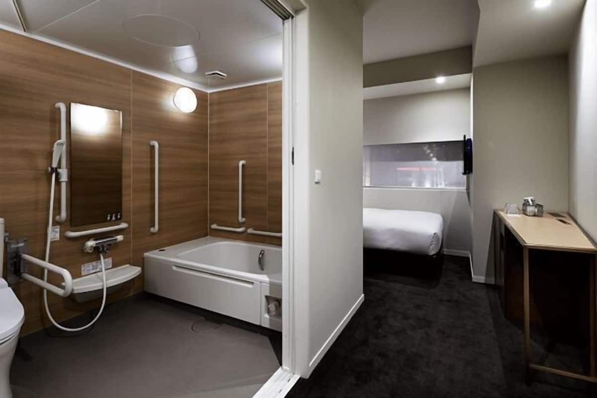 Bathroom | Combined shower/tub, designer toiletries, hair dryer, slippers