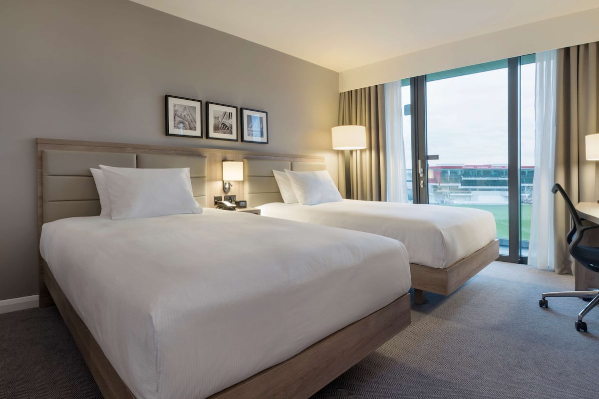 twin room (pitch view) | egyptian cotton sheets, premium bedding, in-room safe, desk