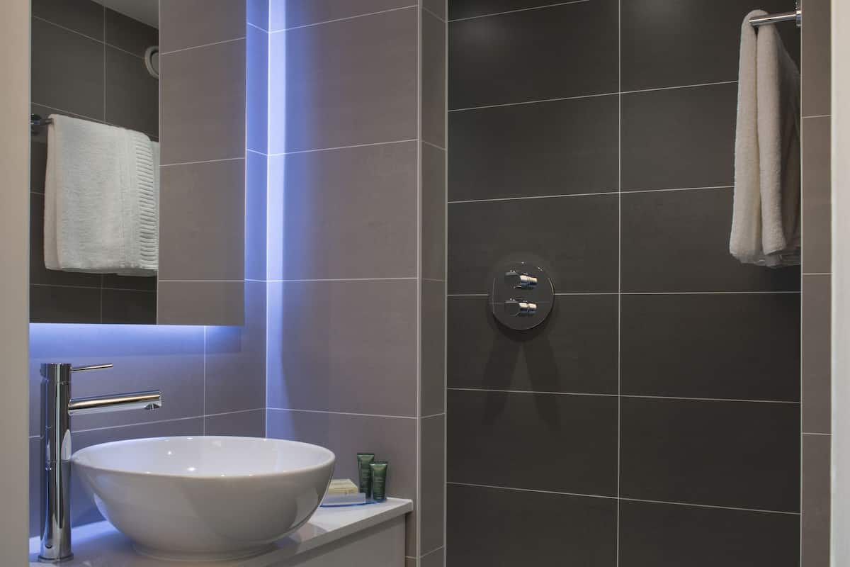 room, 1 king bed | bathroom | designer toiletries, hair dryer, bathrobes, towels