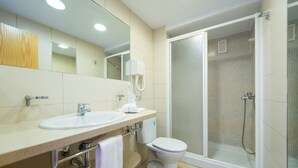 Ein modernes Badezimmer mit Waschbecken, Toilette und einer Duschkabine.