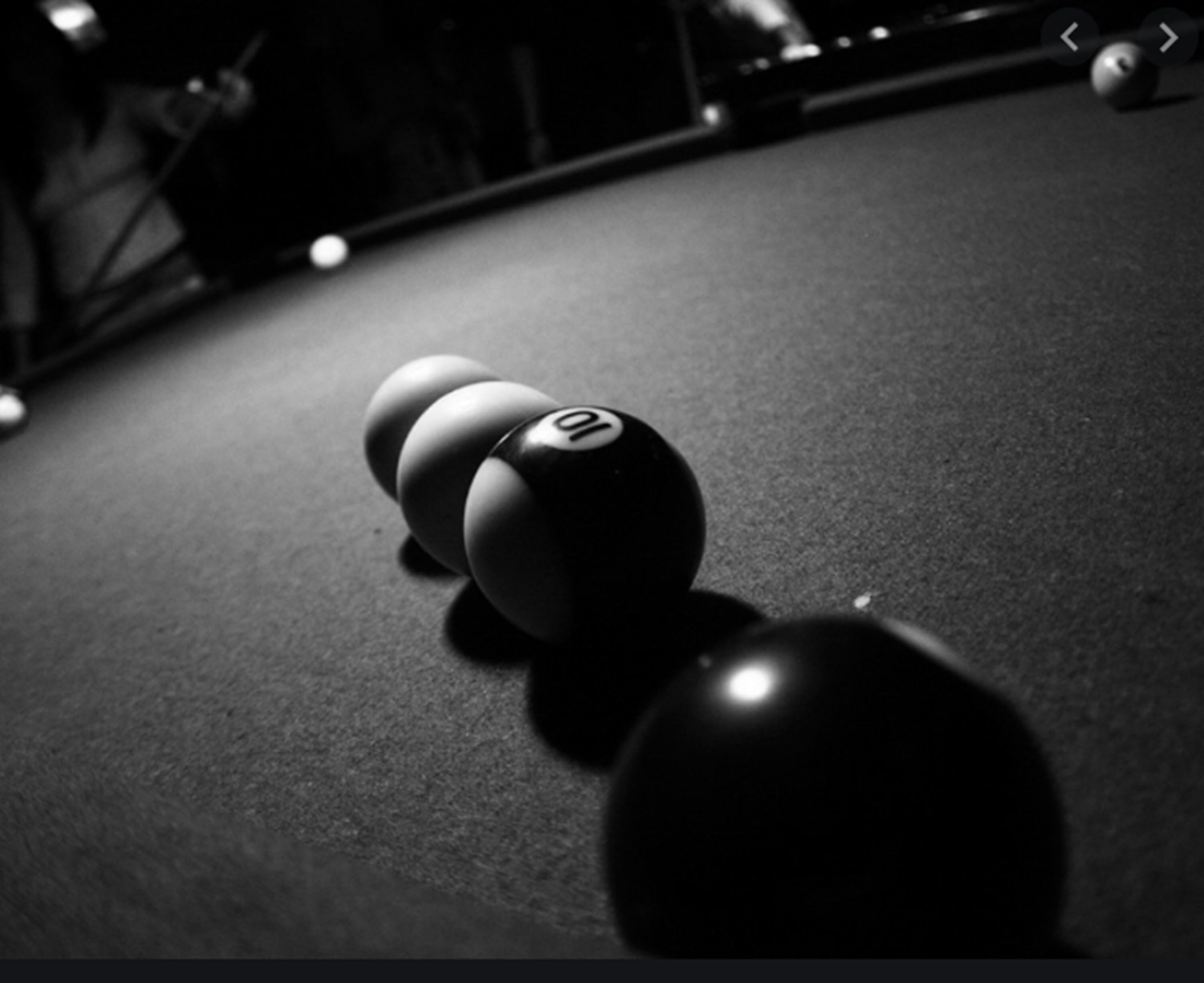 A close-up of a billiards table with numbered balls.