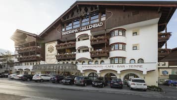 Experience the charm of traditional Alpine architecture at Panorama-Hallenbad Hotel, featuring balconies with flower boxes and offering a restaurant, garage, and bar.