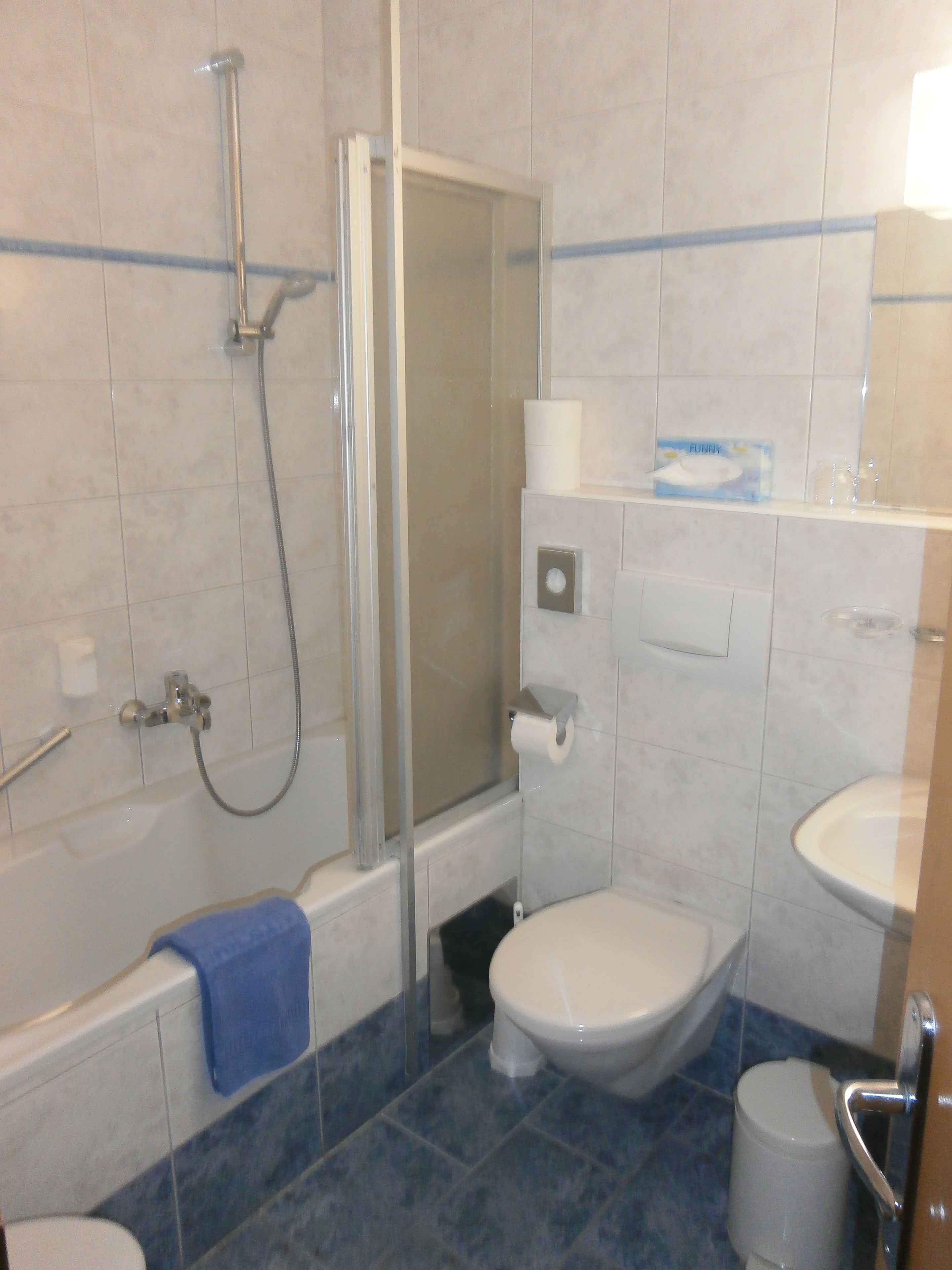 A bathroom with a bathtub, toilet, and shower.