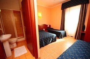 A hotel room with two beds, a bathroom with a sink and toilet, and a shower. - Termini Station Rooms (Rome)