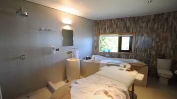 Bathroom features a large shower area, standalone bathtub, and separate toilet.