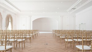 A large, empty room with rows of wooden chairs and a polished wooden floor. - Hotel Kiston (Suleczyno)
