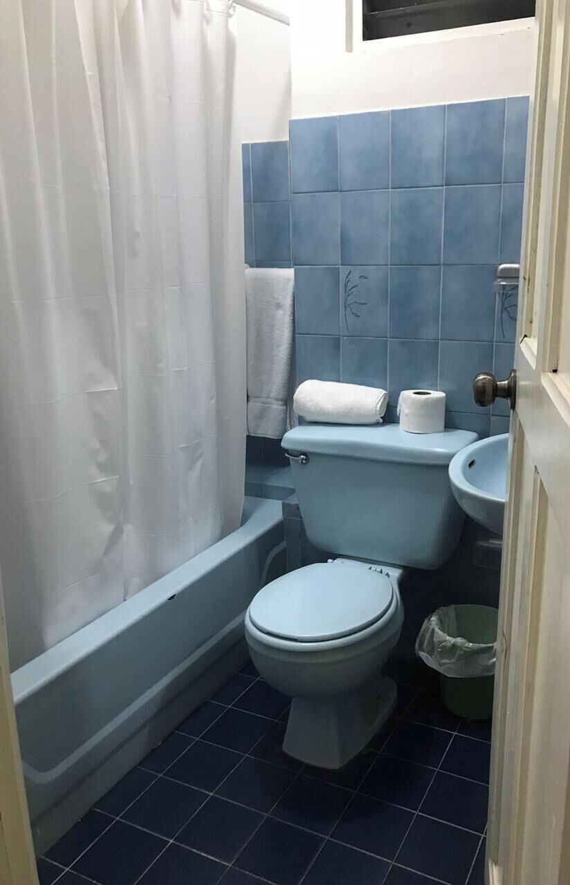 A bathroom with a bathtub, toilet, and sink.