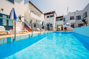 Seasonal outdoor pool, pool umbrellas, pool loungers