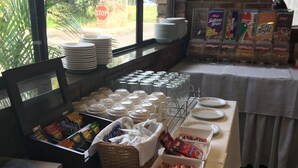 A buffet setup with various food items and utensils.