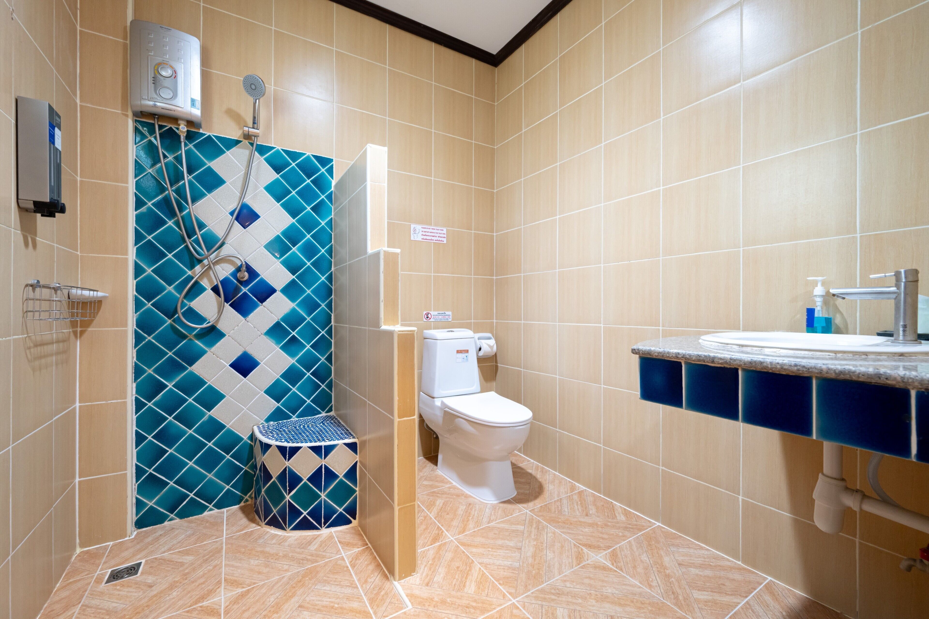 A bathroom with a shower, toilet, and sink.