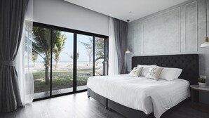 A modern bedroom with a large bed, a view of the beach, and a minimalist design. - SiamBeach Resort (Cha-am)