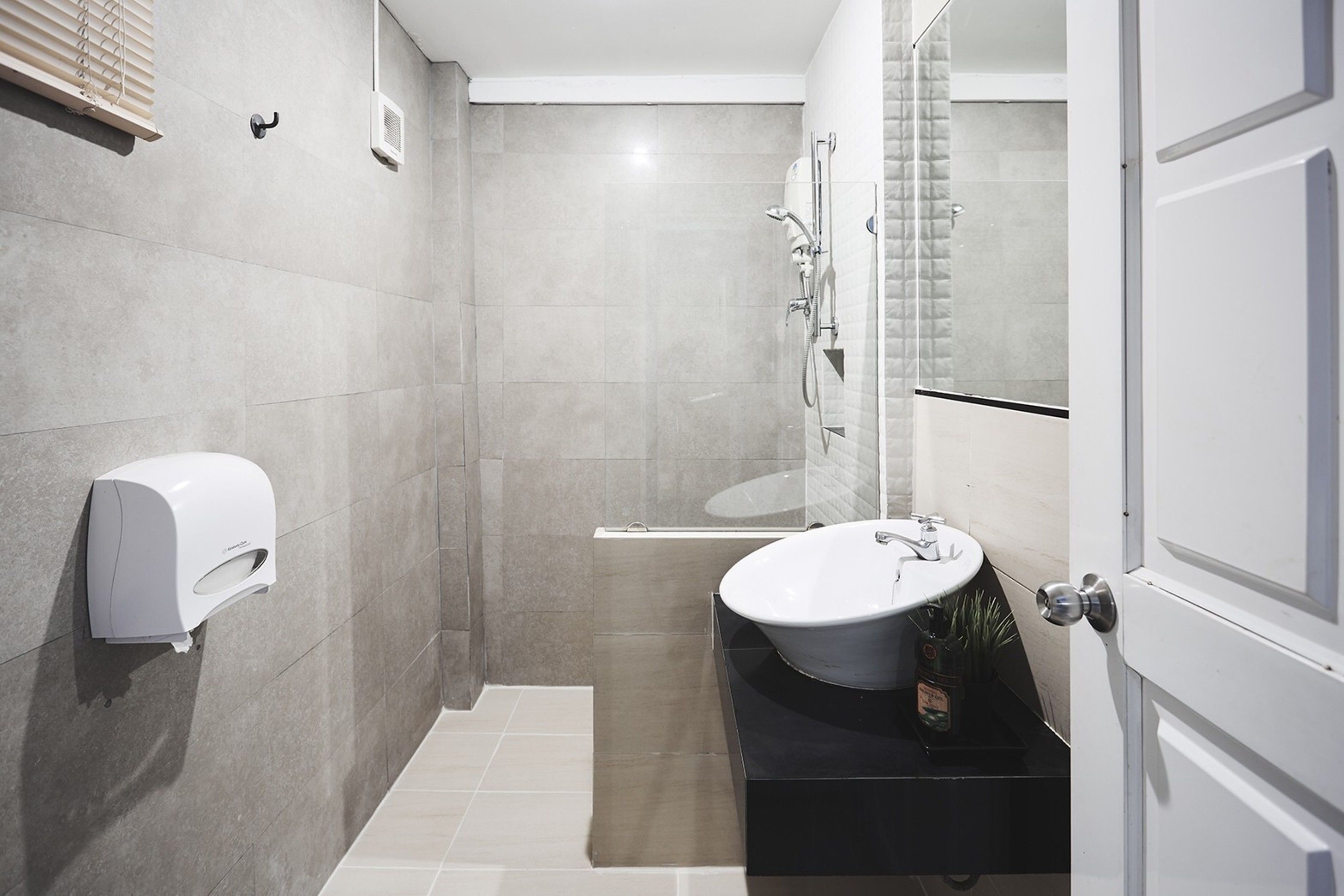 A modern bathroom with a toilet, sink, and shower.