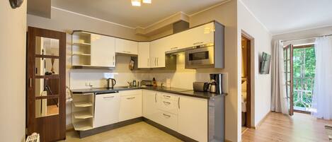 Apartment, 1 Bedroom | Private kitchenette | Full-size fridge, microwave, stovetop, dishwasher