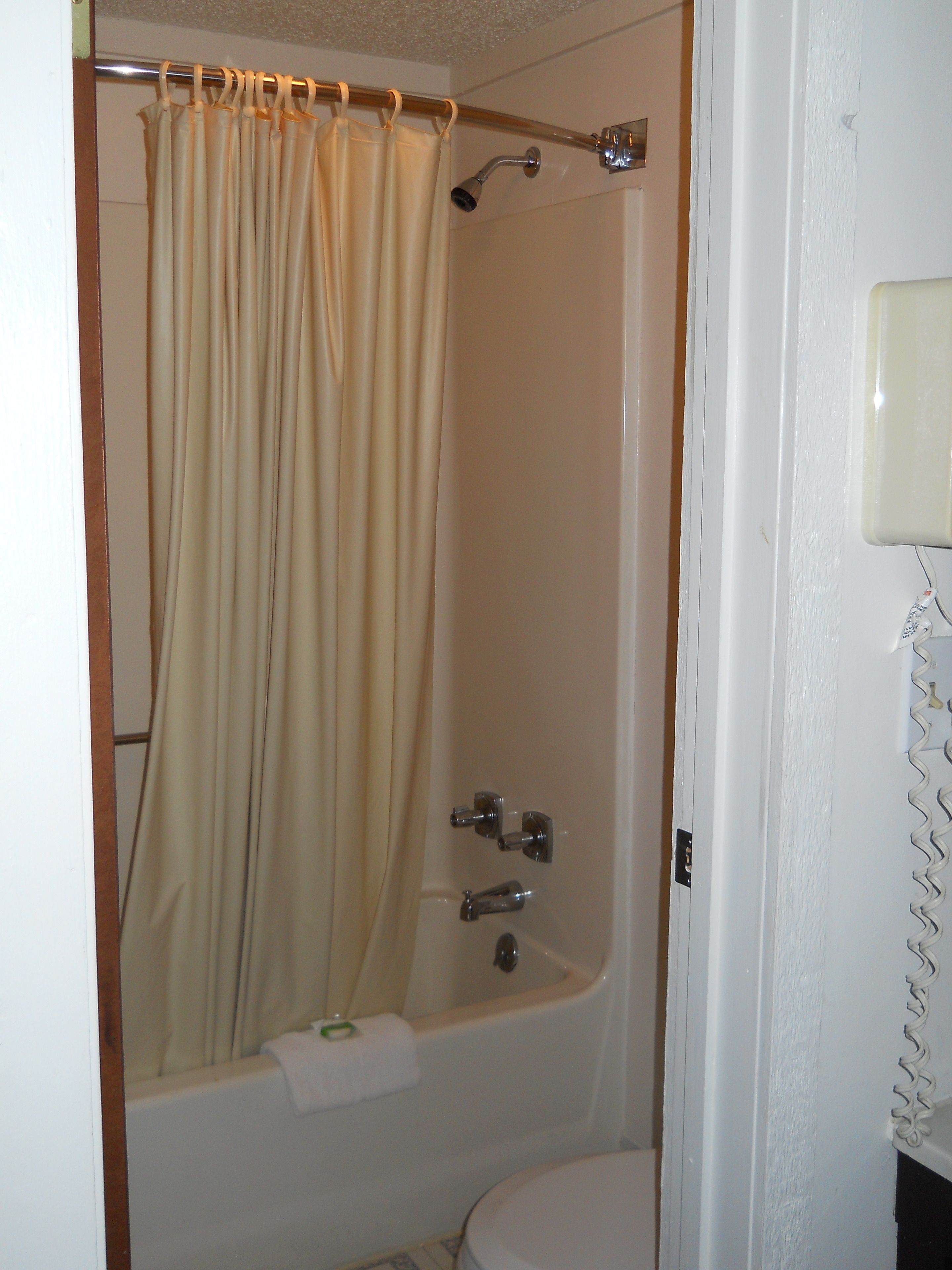 A bathroom with a bathtub, a shower, and a toilet.