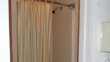 A bathroom with a bathtub, a shower, and a toilet.