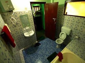 Bathroom features a white sink, mirror, toilet, and bathtub.
