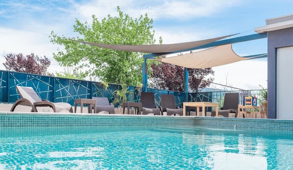 Seasonal outdoor pool, open 10:00 AM to 9:00 PM, pool umbrellas