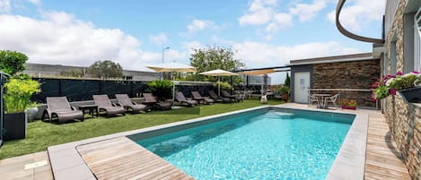 Seasonal outdoor pool, open 10:00 AM to 9:00 PM, pool umbrellas