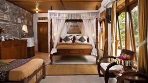 A traditional room with a four-poster bed, wooden furniture, and a view of greenery outside. - Ketut's Place Bed & Breakfast Ubud (Ubud)