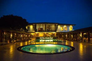 The Full Moon Garden Hotel with a swimming pool and outdoor seating.