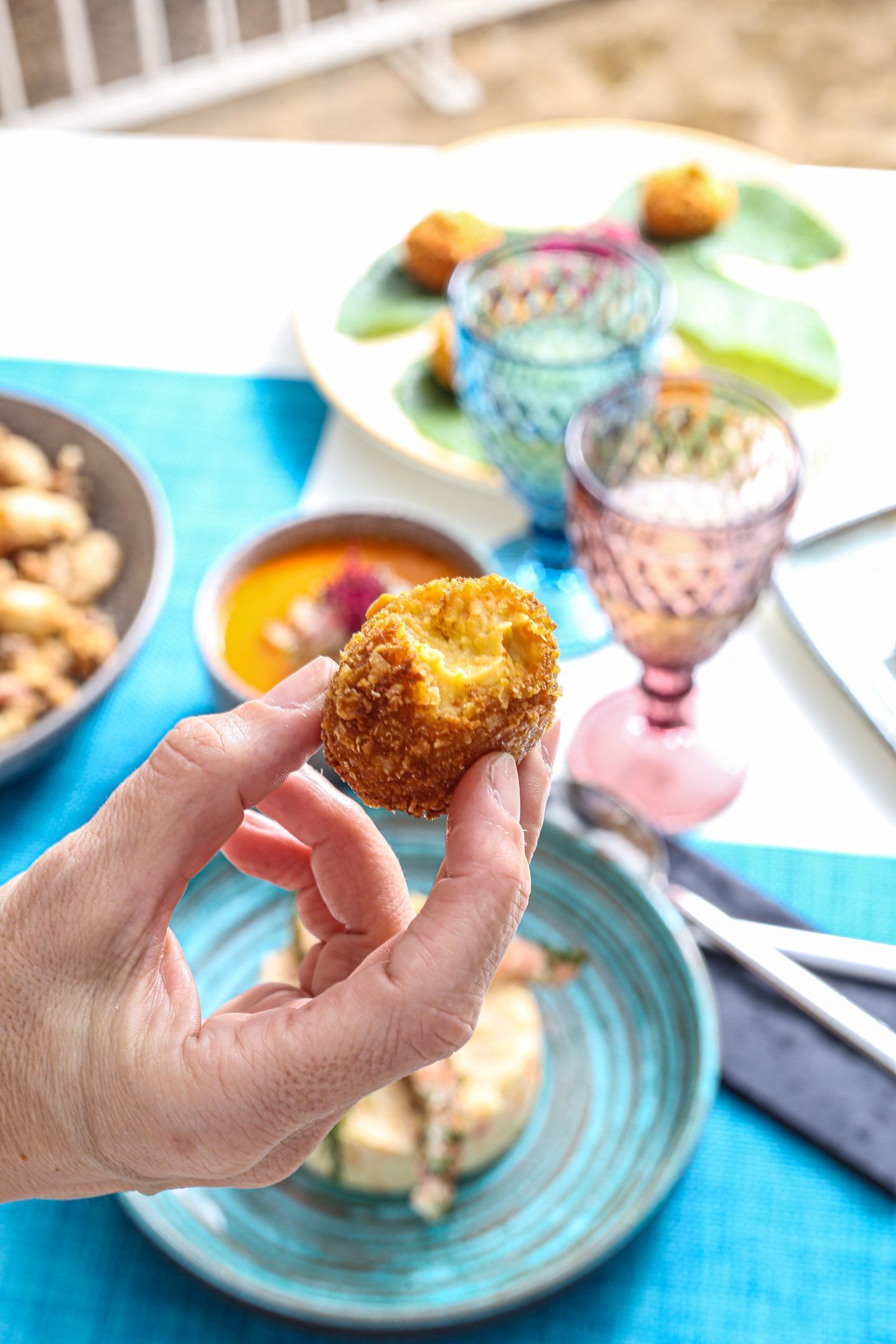 A hand holding a fried food item.