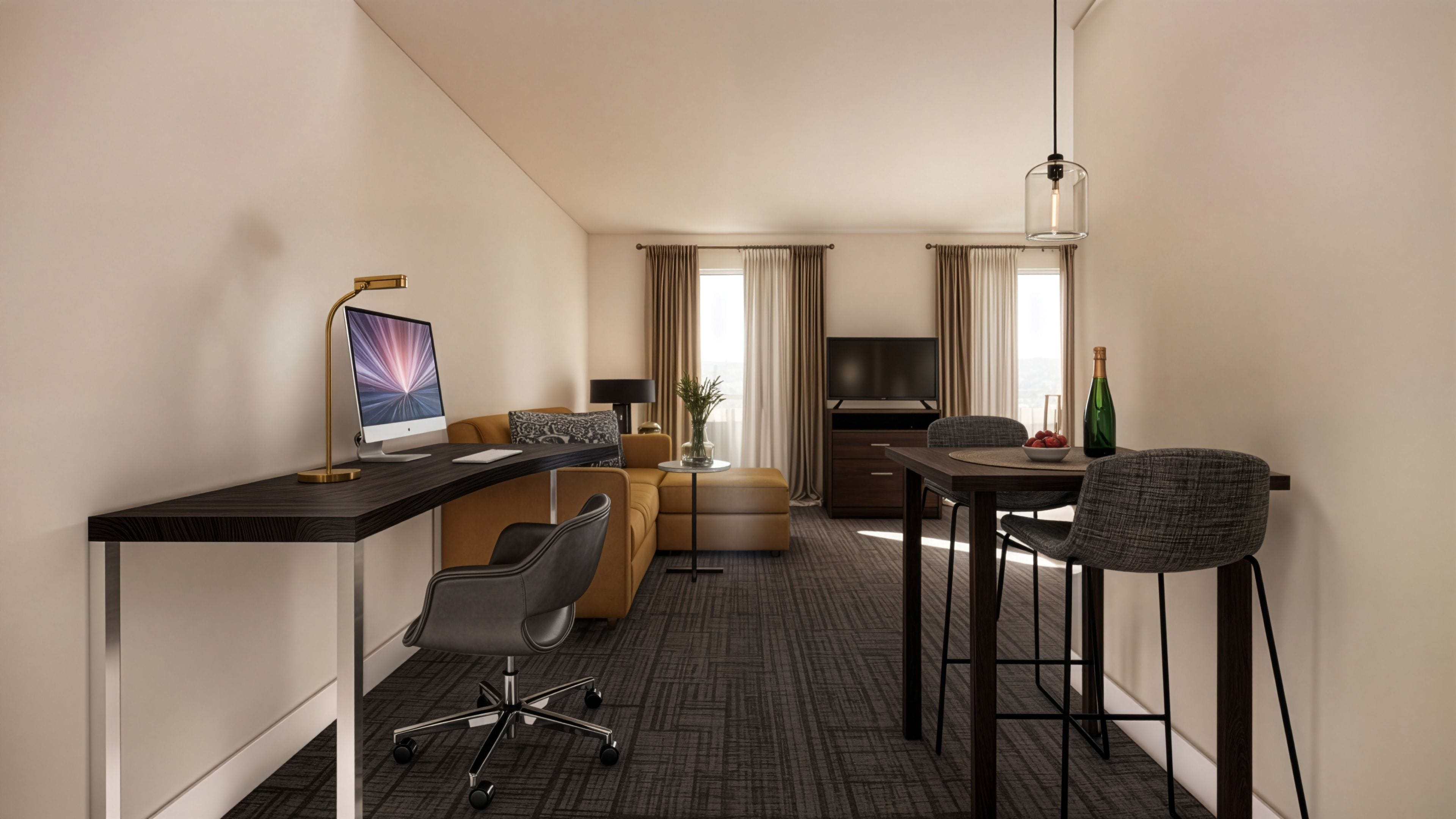 A hotel room with a desk, a laptop, a sofa, a TV, and a dining area with chairs and a table.