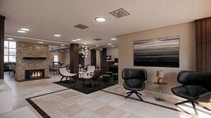 A spacious lobby with a fireplace, leather chairs, a flat-screen TV, and a large abstract painting. - Residence Inn by Marriott Edmonton West (Edmonton)