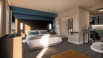 Een moderne hotelkamer met een groot bed, een bureau, een stoel, een bijzettafeltje en een potplant.