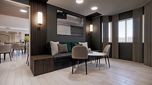 A modern living room with a sofa, chairs, a coffee table, and a dining area. - Residence Inn by Marriott Edmonton West (Edmonton)