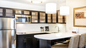 A modern kitchen with stainless steel appliances, a built-in microwave, and a coffee maker. - Residence Inn by Marriott Edmonton West (Edmonton)