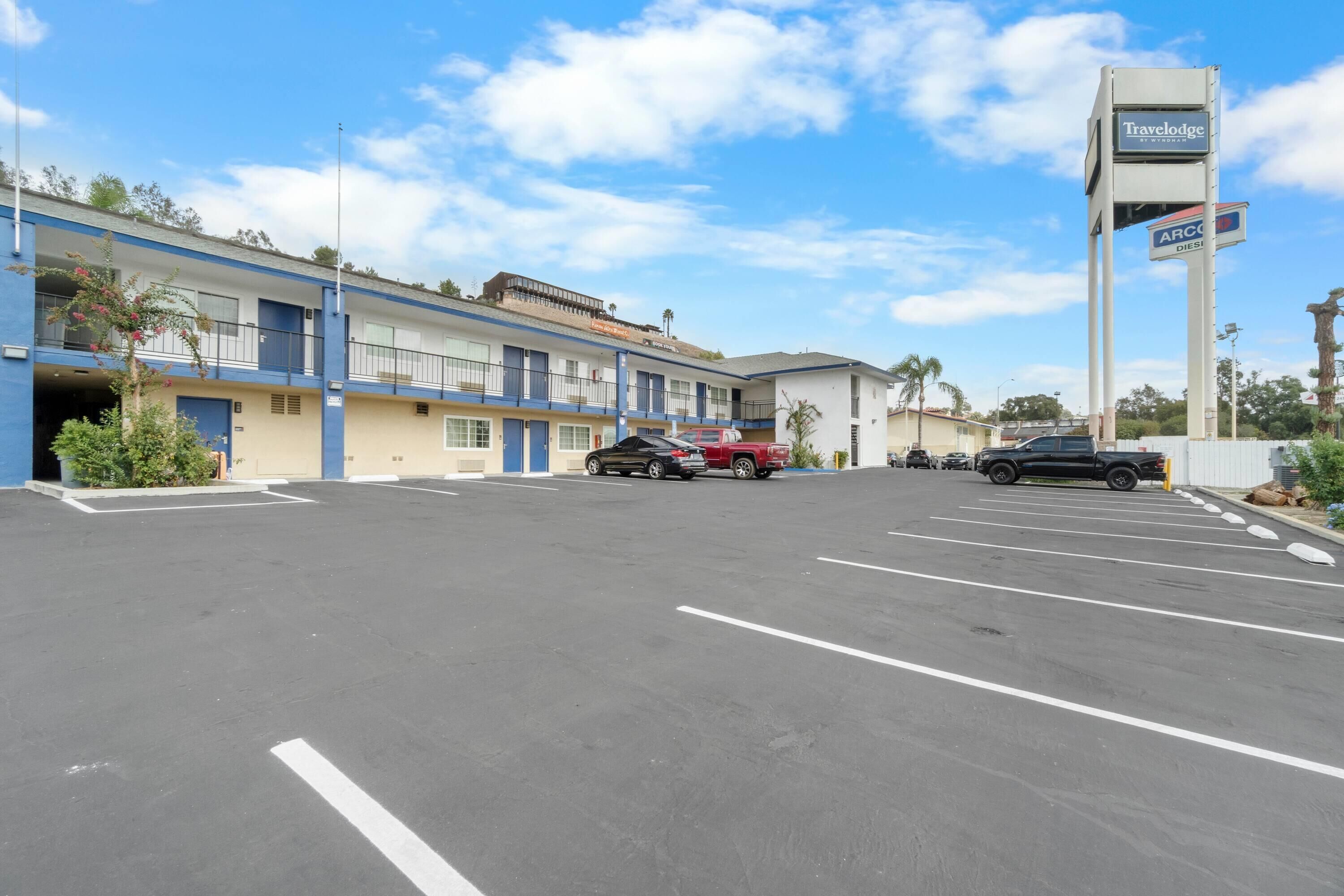A Travelodge motel with a parking lot and a sign indicating ARCOTA DIESEL.