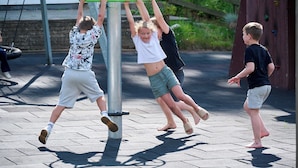 Children playing on outdoor equipment.